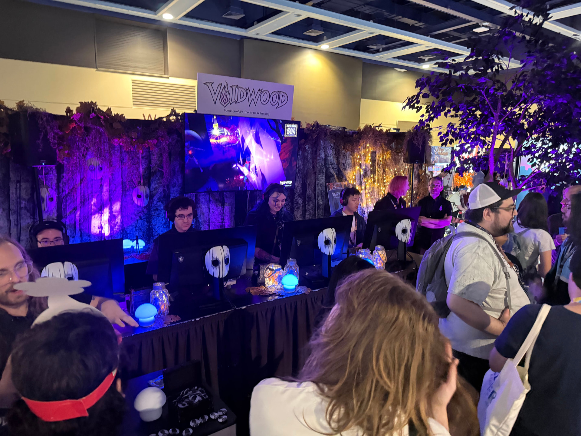 The Voidwood booth glowing purple while players take their seats